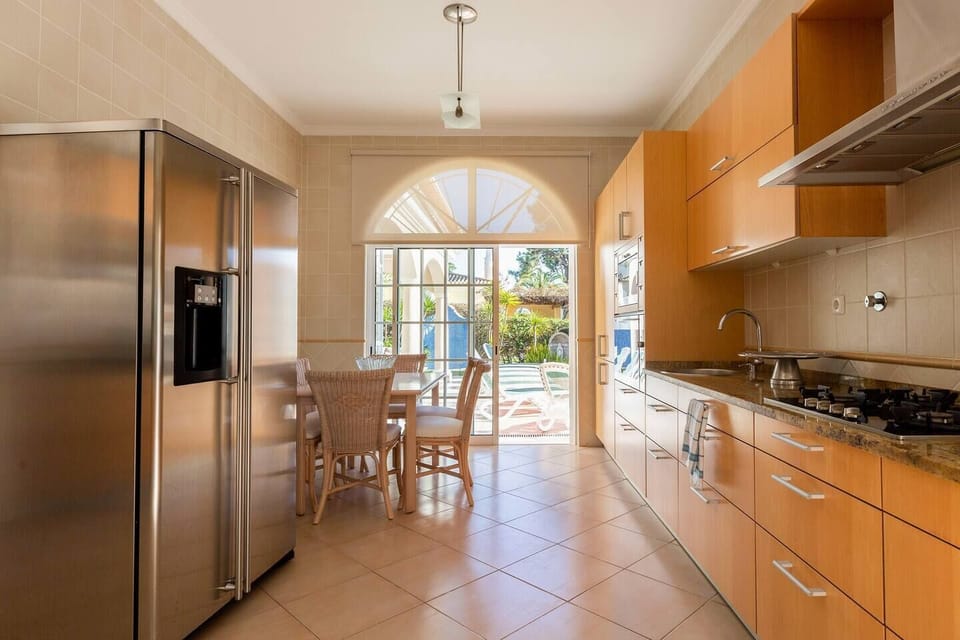 Kitchen area opening onto the pool and garden area 