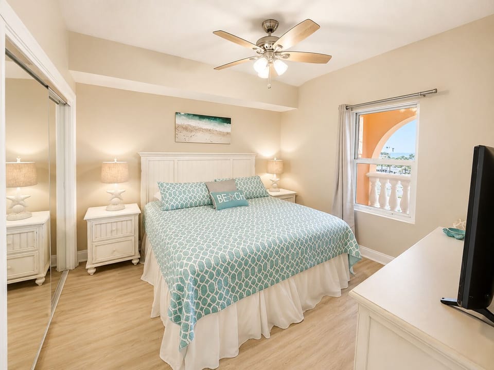 Unwind in your peaceful bedroom retreat, featuring cozy bedding, gentle ceiling fan, and charming window views for restful nights.