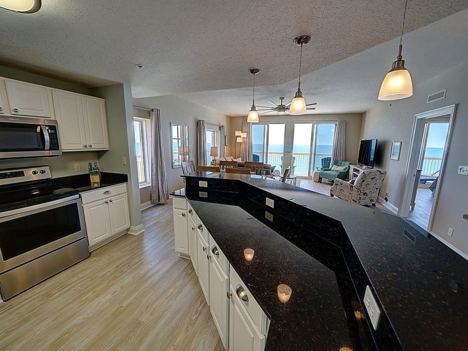 Your gourmet kitchen features granite countertops and opens to stunning ocean views, perfect for cooking while enjoying the sea breeze.