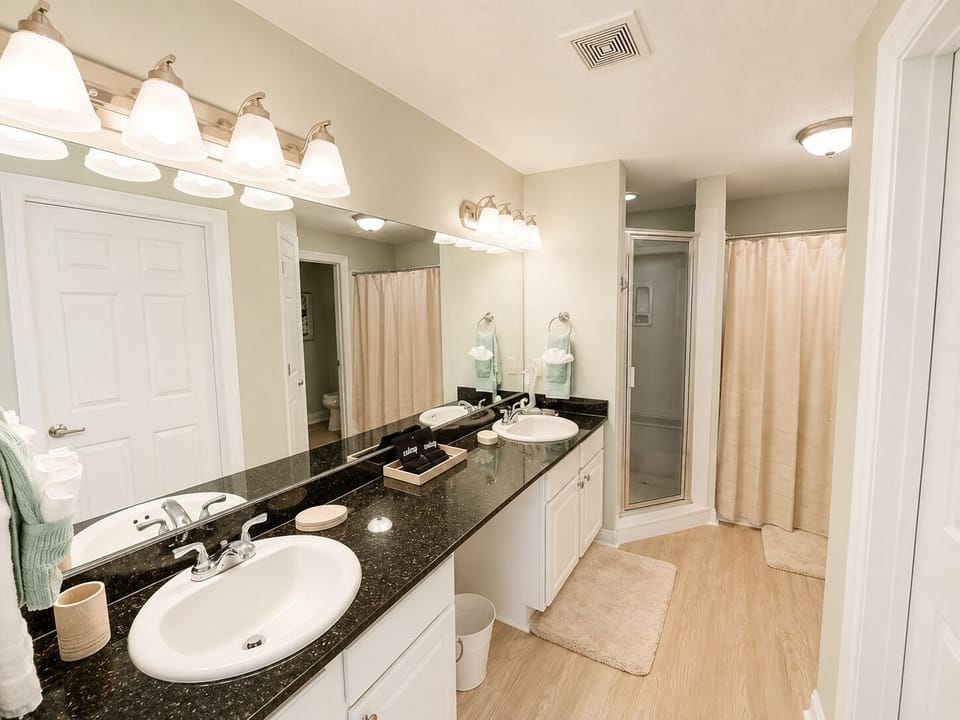 Unwind in your spacious master bathroom featuring dual vanities, elegant fixtures, and a relaxing tub for those perfect evening soaks.