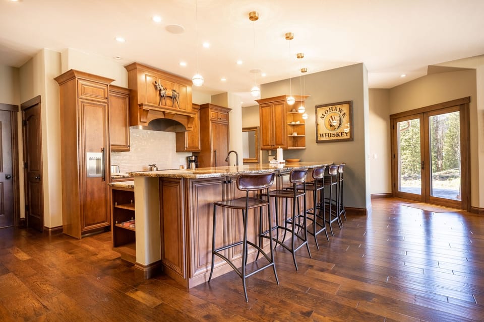 Your gourmet kitchen awaits with warm wood cabinetry, granite countertops, and a spacious island perfect for gathering with friends.