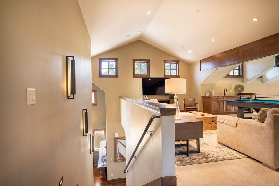 Your spacious loft living area features vaulted ceilings, warm wood accents, and comfortable seating for relaxing evenings with entertainment.