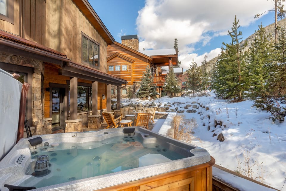 Soak in your private hot tub while snow glistens around this mountain retreat, complete with cozy patio seating.