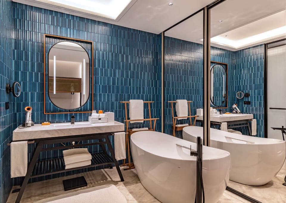 Separate tub and shower, rainfall showerhead, designer toiletries
