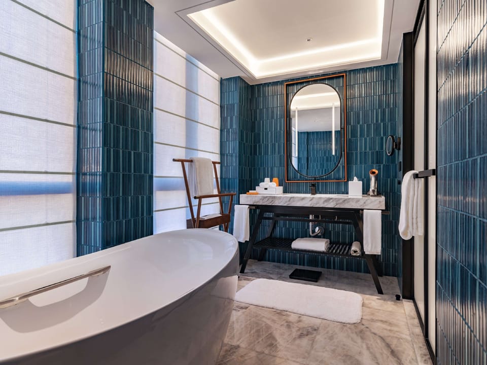 Separate tub and shower, rainfall showerhead, designer toiletries