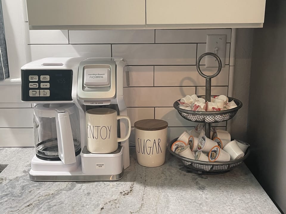 FlexBrew stocked with coffee filters/ground/pods, creamer and sugar