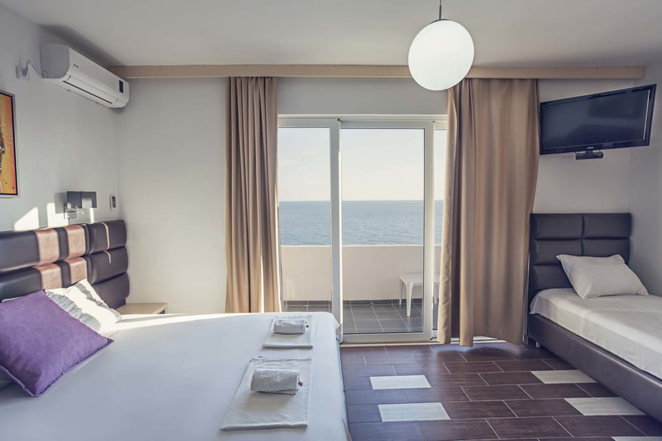 Standard Studio, Partial Sea View | Minibar, in-room safe, individually decorated, individually furnished