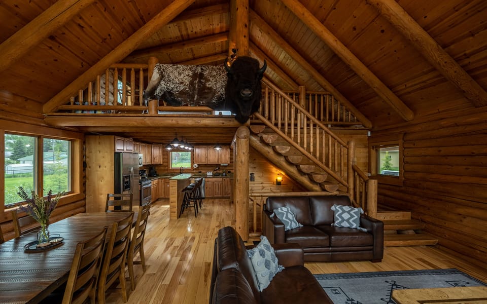 Beautiful log cabin with open living area and leather sofas