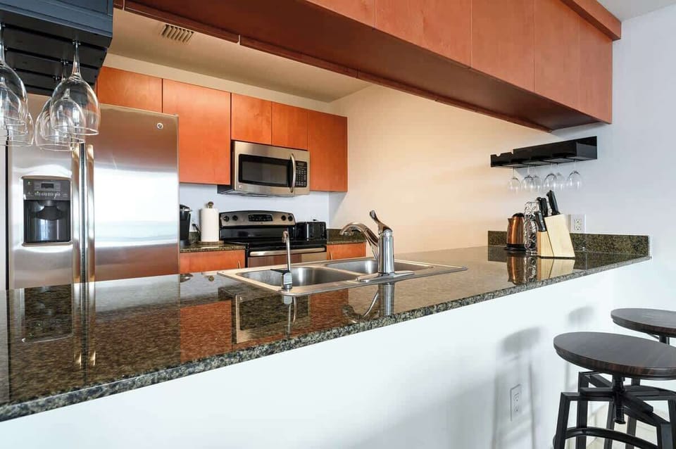 Enjoy a fully stocked kitchen with granite counters, wine glass rack, and casual bar seating. Perfect for couples or solo guests who love to cook and unwind.

