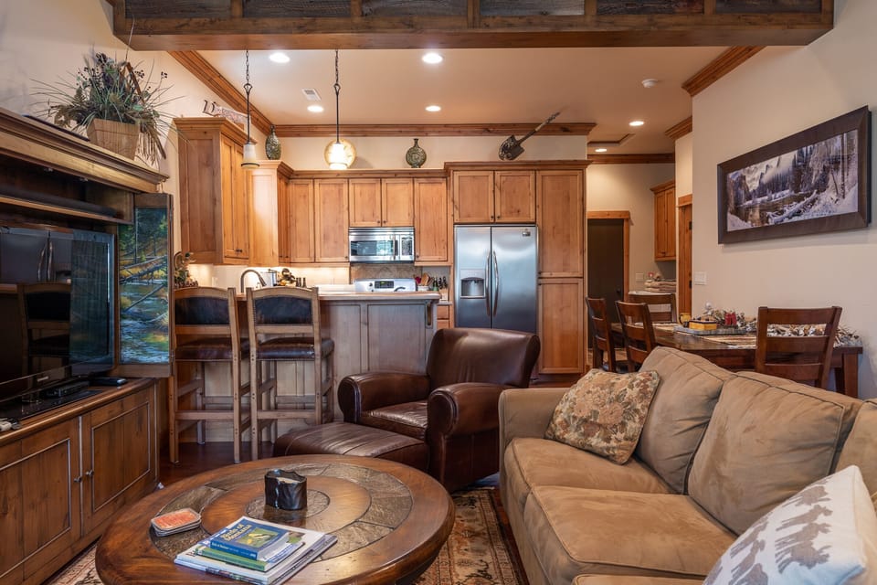 There is a cozy couch and two chairs situated to enjoy the ambiance of the fireplace.