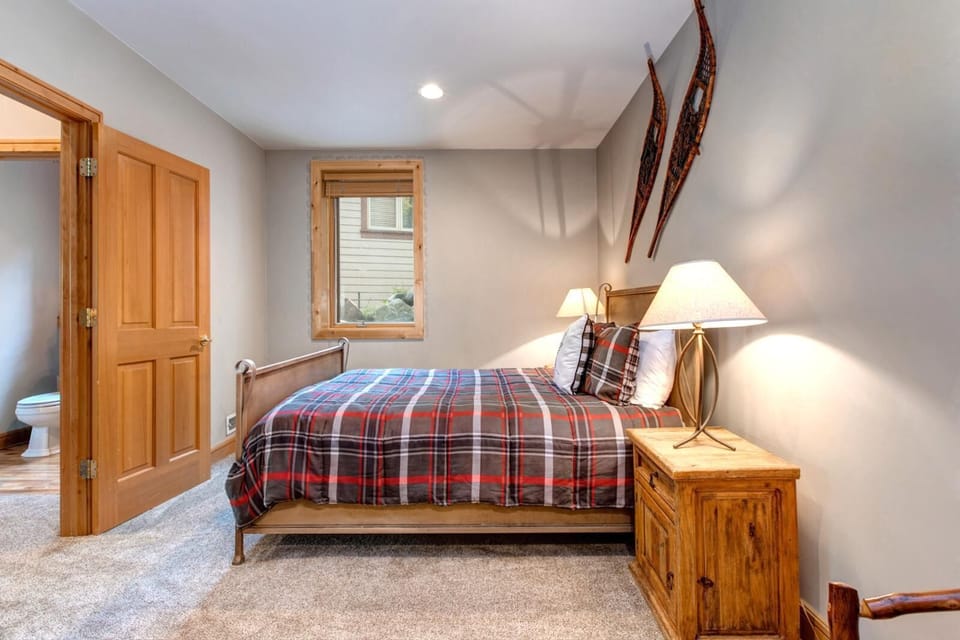 Another view of the bunk room shows cozy lighting and a playful, lodge-inspired design perfect for younger guests.