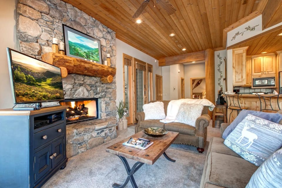A cozy second living area provides extra lounge space, featuring a sofa sleeper, Smart TV, and access to the deck. Ideal for families or larger groups.