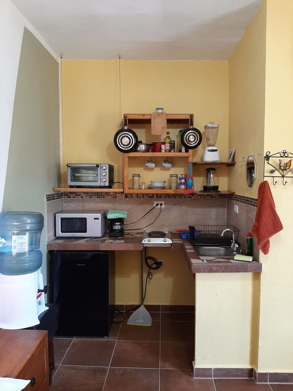Full kitchen, sink, small fridge/freezer, stove tops, oven, microwave, pots pans