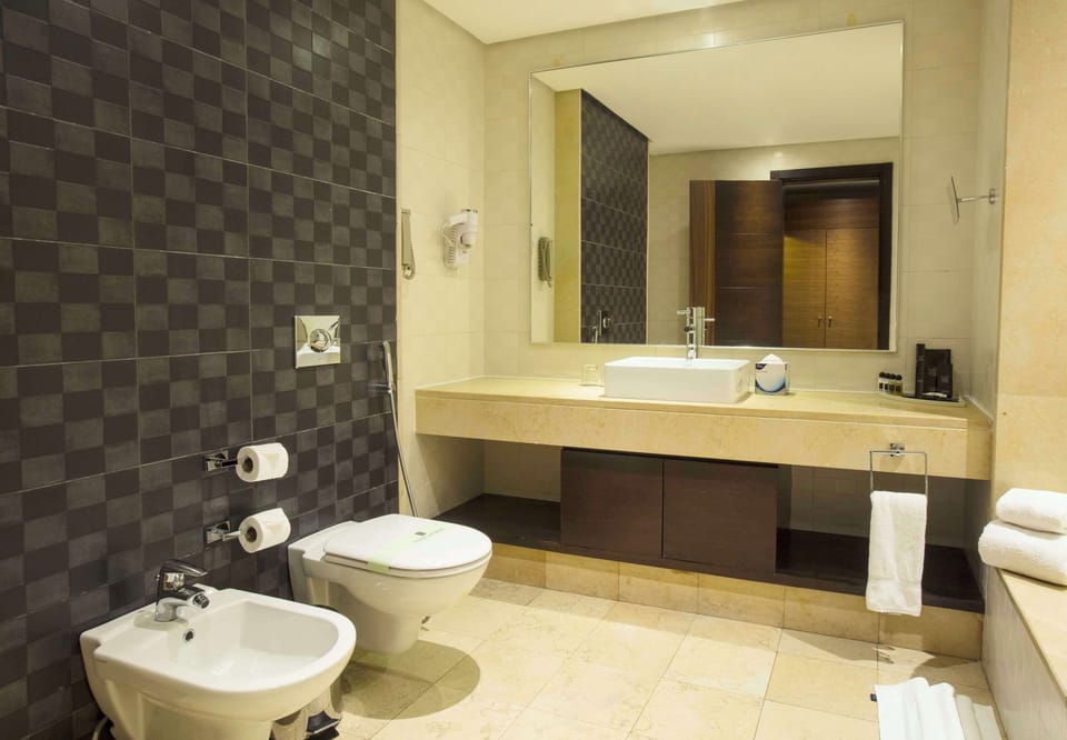 Executive Suite | Bathroom | Shower, designer toiletries, hair dryer, bathrobes