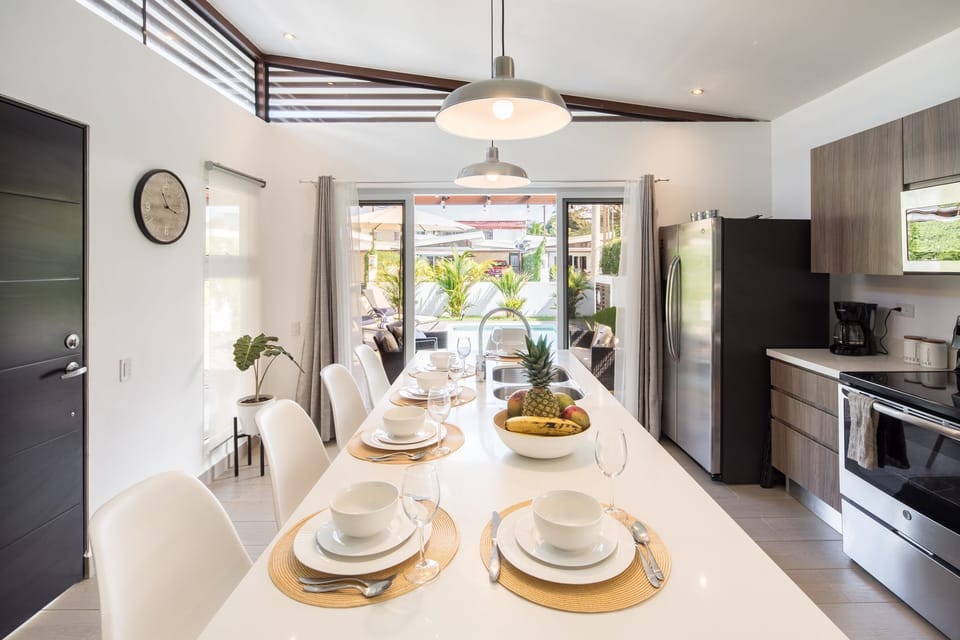 A large, open concept kitchen, dining and living room. 