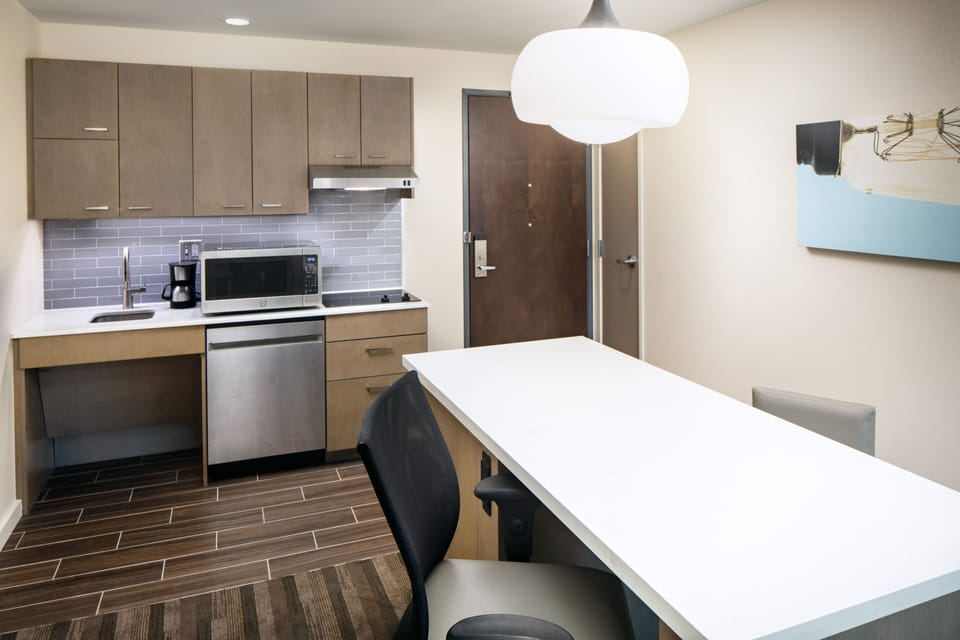 Hypo-allergenic bedding, desk, laptop workspace, blackout drapes