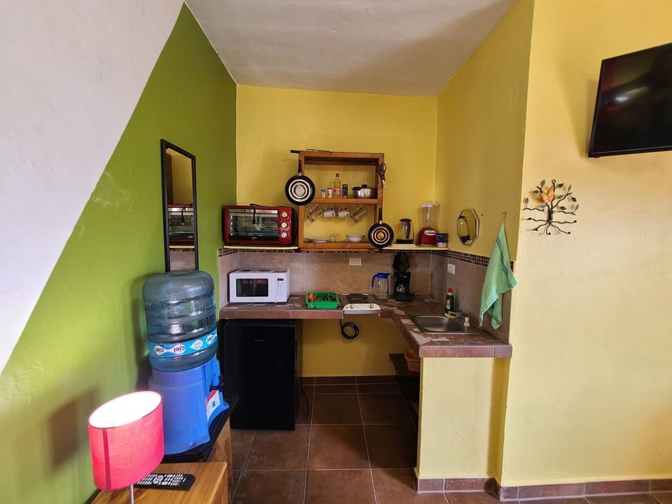 Full kitchen, sink, small fridge/freezer, stove tops, oven, microwave, pots pans