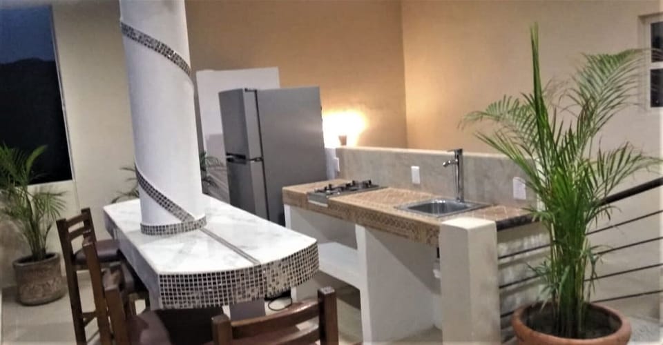 BBQ Common Area , Gas Stove top, Bar/Dining sink Views stairs to Roof.