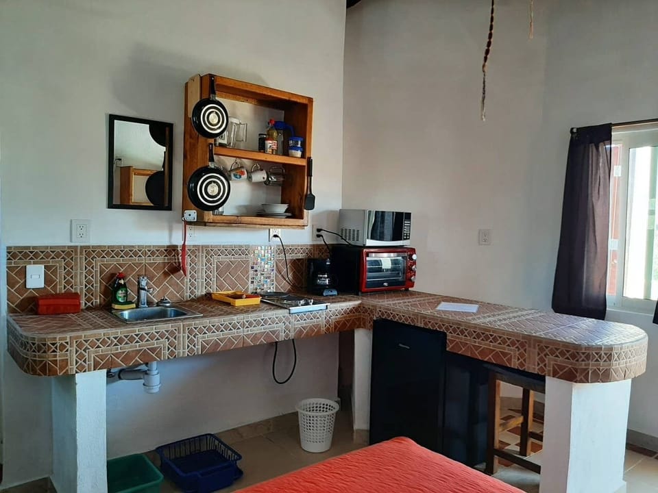 Full kitchen, sink, toaster oven, elec. 2-top stove, window view, coffee, pots +