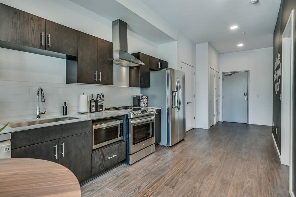 Well stocked kitchen with stainless steel appliances. 