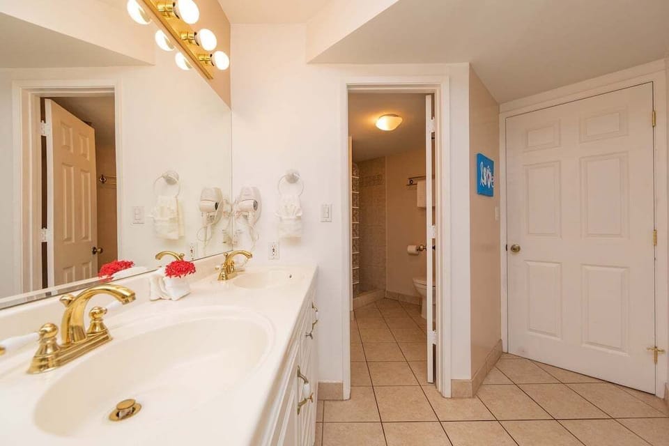 Large master bathroom vanity with dual sinks and modern finishes.
