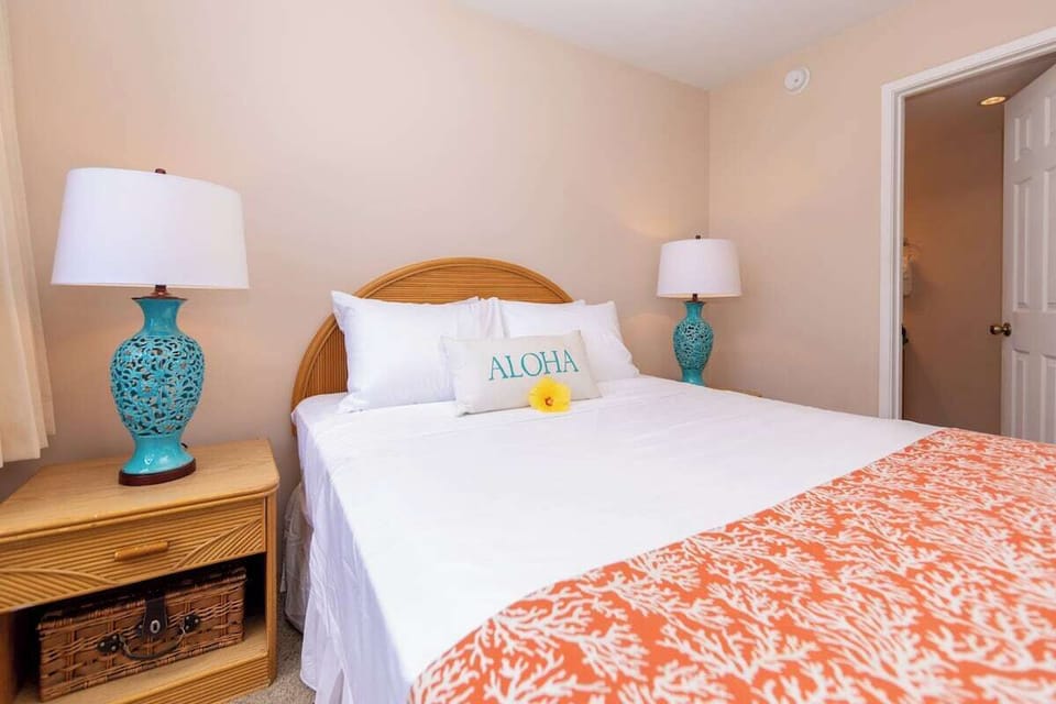 Bright second bedroom featuring a queen bed and comfortable furnishings.