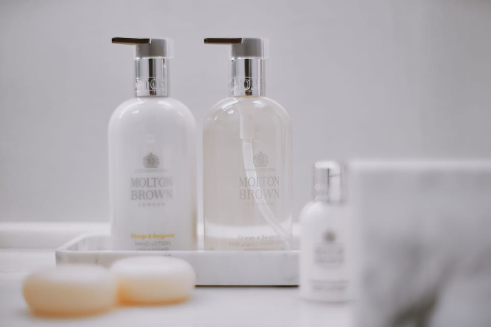 Shower, designer toiletries, hair dryer, slippers