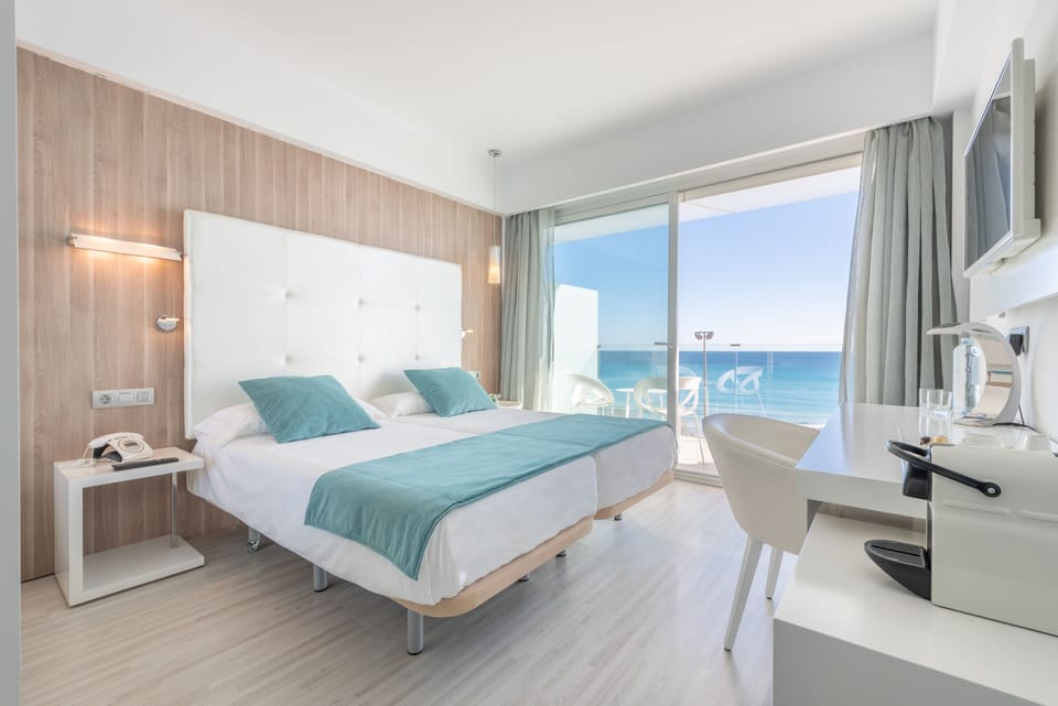 Double Room, Balcony, Sea View | Minibar, in-room safe, desk, laptop workspace