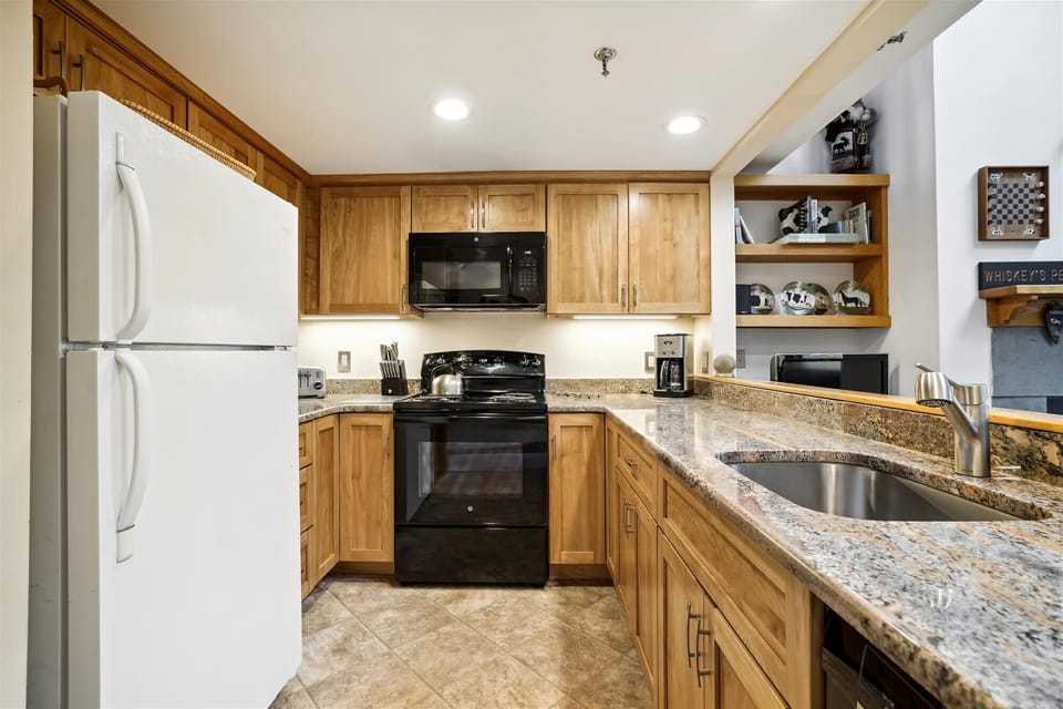 Well-appointed kitchen with granite countertops, full-size appliances, and everything needed for easy meals during your stay.