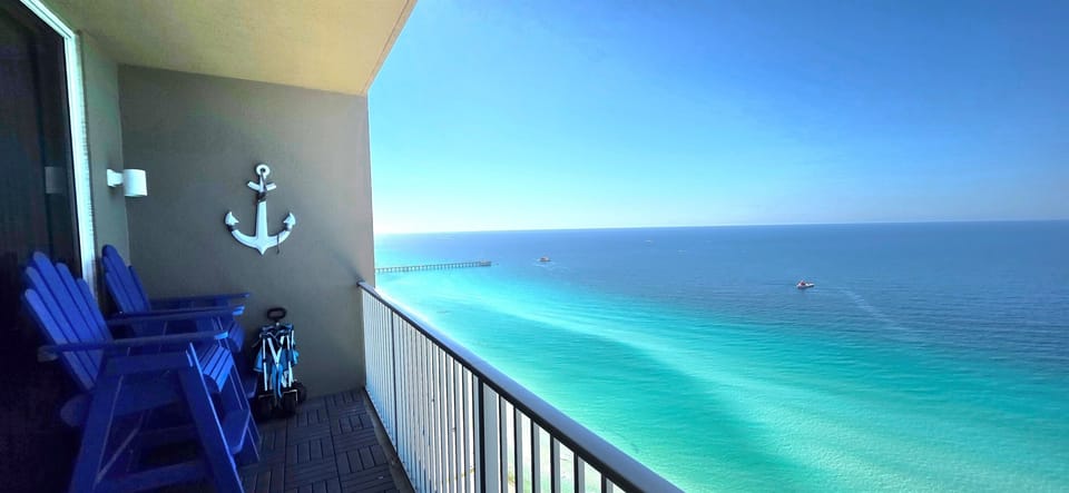 Balcony Bliss: Stunning ocean views from vibrant chairs—your front-row seat to paradise!