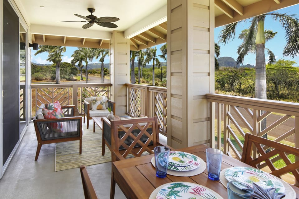 Private Lanai with cozy seating and a dining area, surrounded by tropical views.