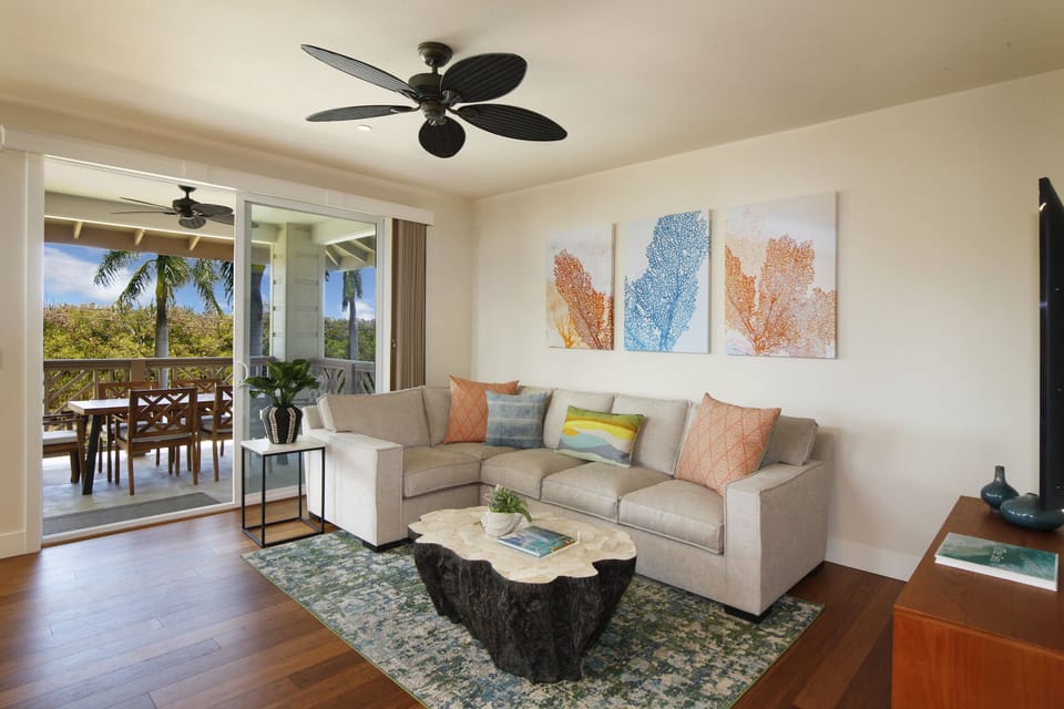 Living room with access to the private lanai and tropical views.