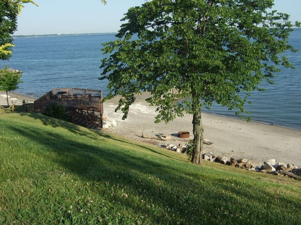 Park deck and beach just down the grassy hill from An Old Lake House