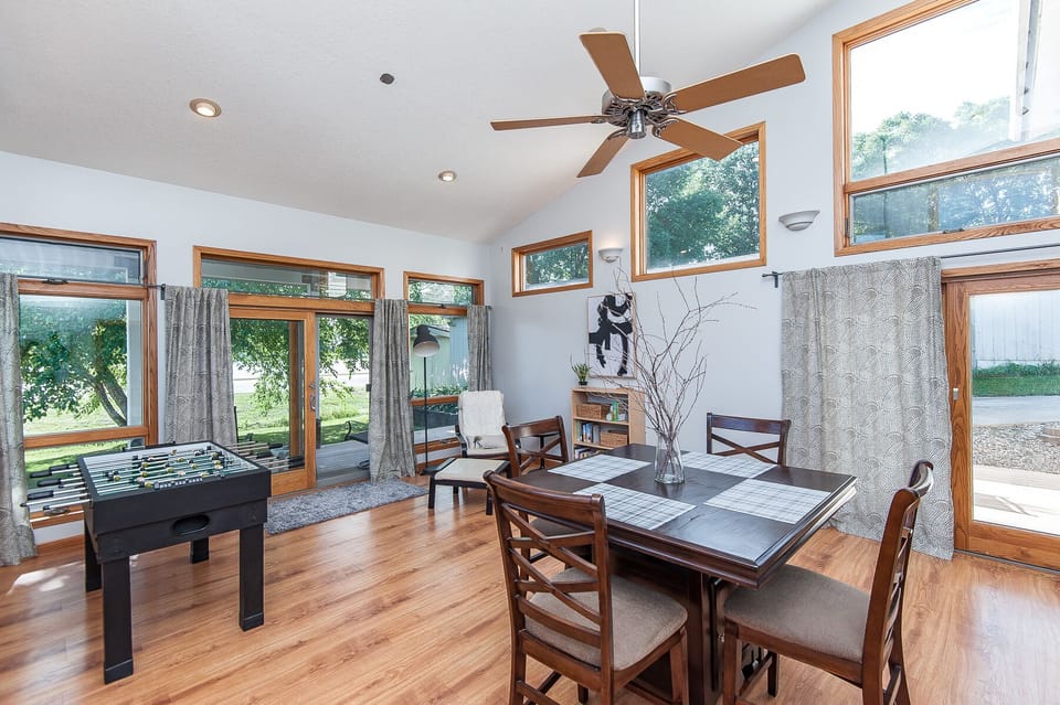 Rec room with high-top table and 4 chairs, foosball table, reading corner & bike