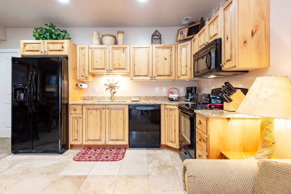 This well-equipped kitchen features a stove, dishwasher, microwave, and other appliances for your convenience and culinary enjoyment.
