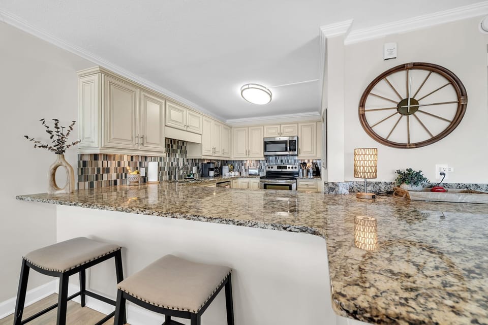 Your gourmet kitchen awaits with granite counters, breakfast bar seating, and stainless steel appliances for easy meal prep.