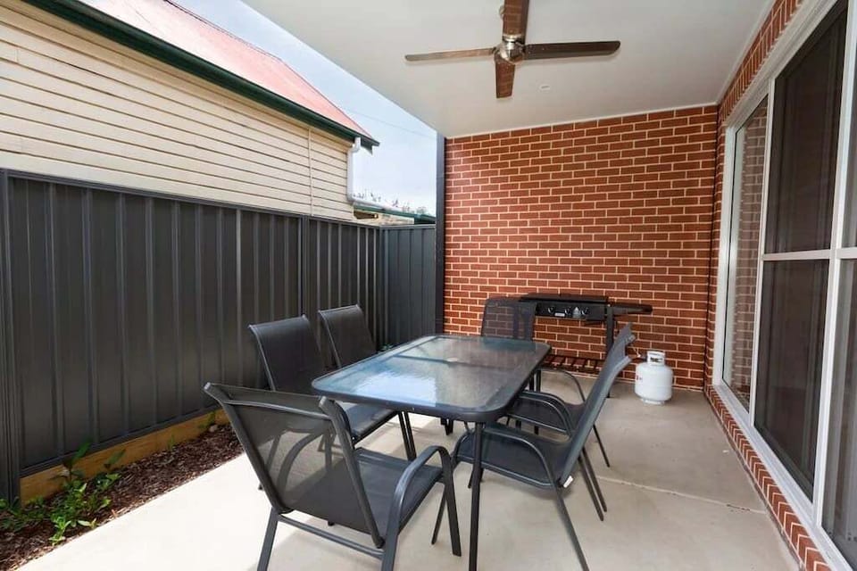 Patio with outdoor furnitures and BBQ.