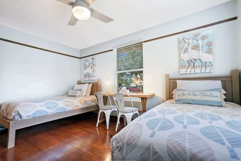 Third bedroom with two twin beds, desk area and large closet.
