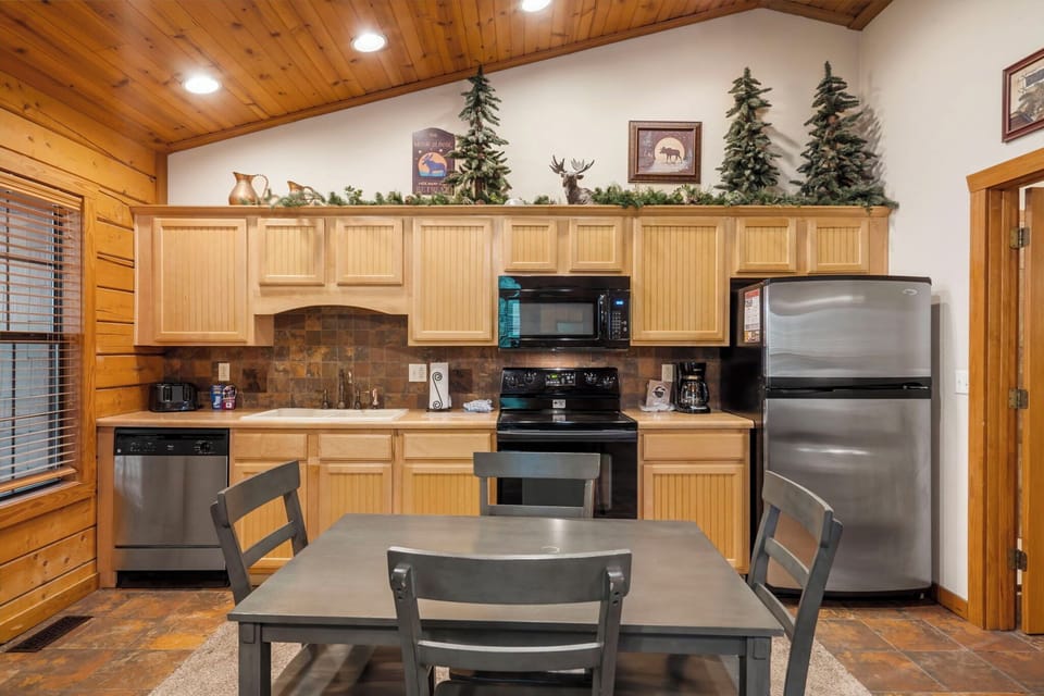 Fully Equipped Kitchen Includes Full-Size Appliances, All 
Wood Cabinets, and Dining Table