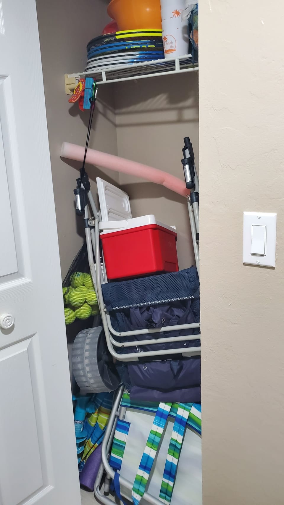 front closet with beach cart, chairs, umbrella,  tennis rackets