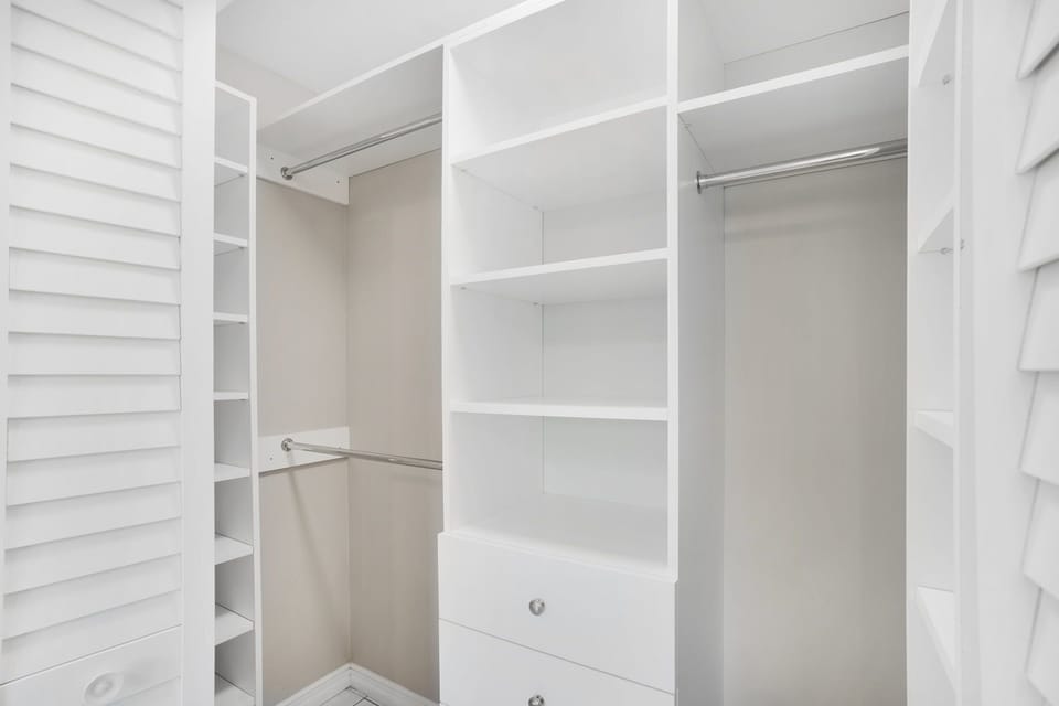 Master Bedroom has two walk in closets with shelves, drawers and hanging.