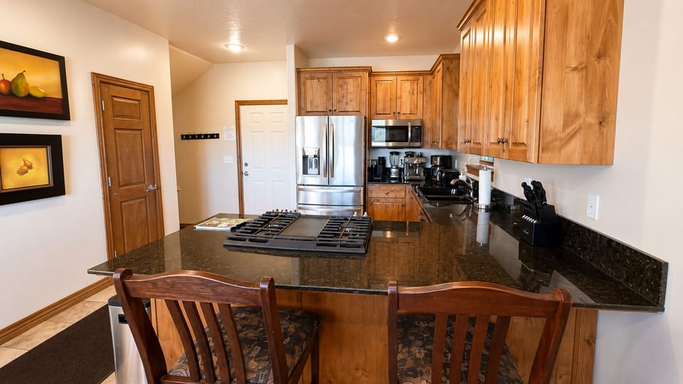 The open-concept kitchen keeps everyone connected, with generous counter space and seating for casual meals and conversation.