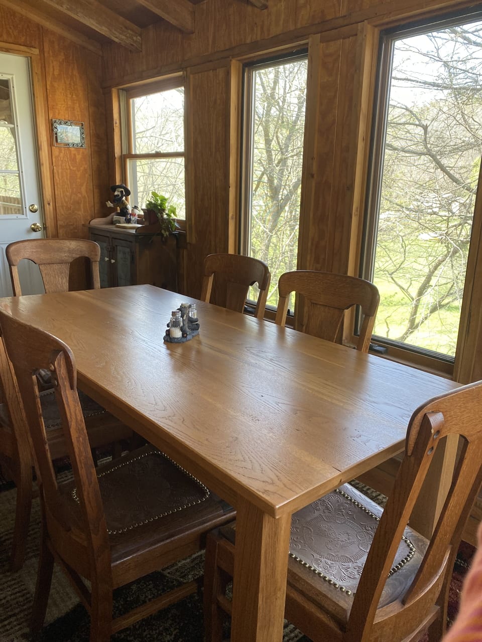 Dining room table; seats 6. Large windows give a view of the creek.