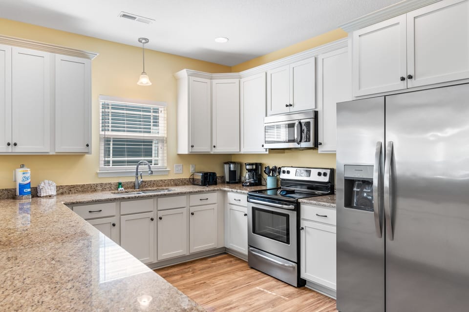 Your fully equipped kitchen awaits with granite counters, stainless appliances, and everything needed to prepare memorable meals during your stay.