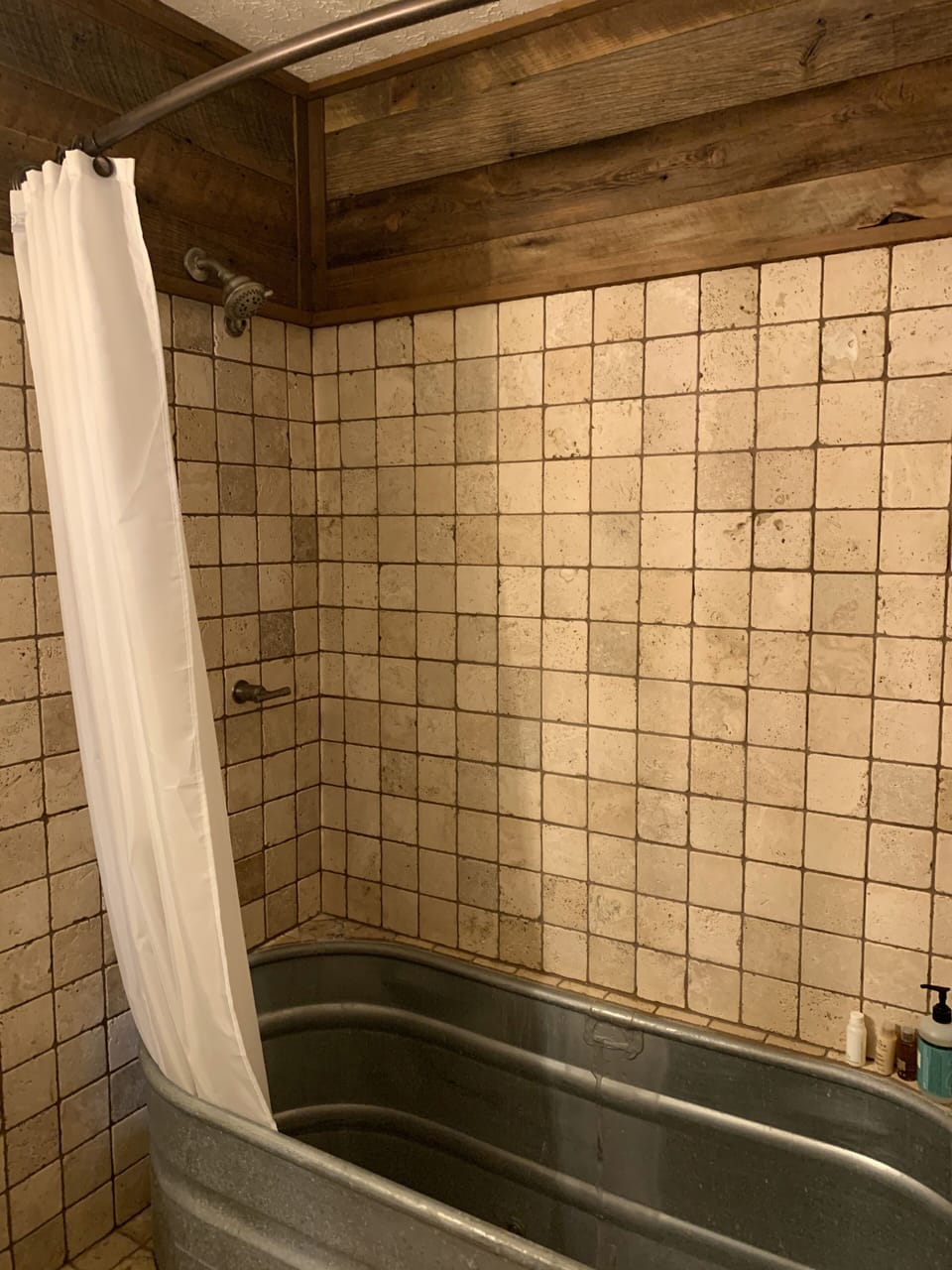 Unique rustic bathroom with a roomy tin bathtub for you to try.