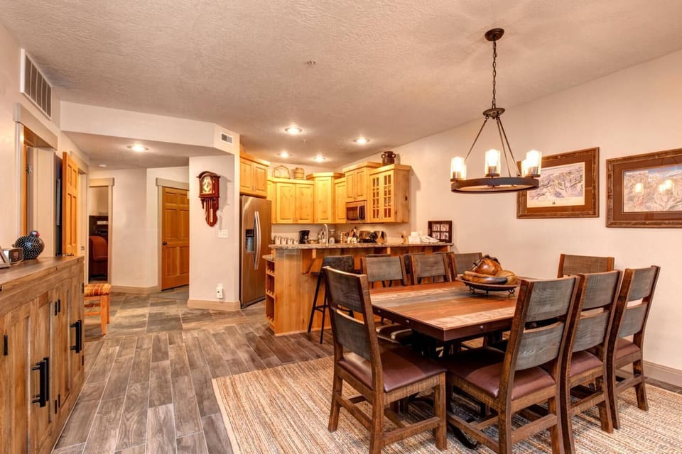 Dine together at the wooden table for eight, perfectly placed between the kitchen and living area for effortless flow and connection.