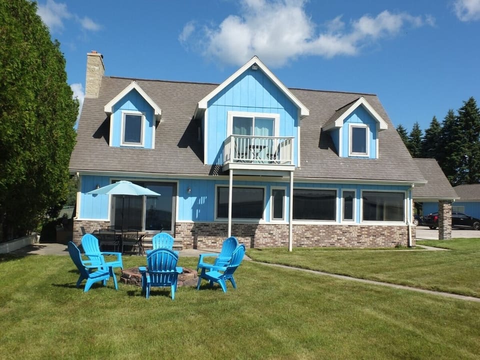 OVERALL:  A good overview of the back of the house, which faces Lake Huron.  As shown, there is a nice fire ring and also outdoor dining furniture in the backyard.