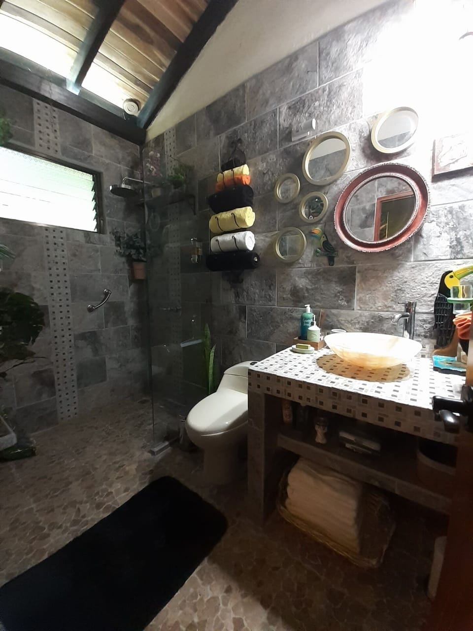 Toucan Bath with Walk-in Rain Shower and a Natural Onyx Vessel Sink