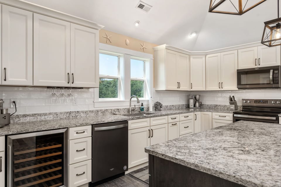 Simplicity and style converge in the white-themed kitchen.