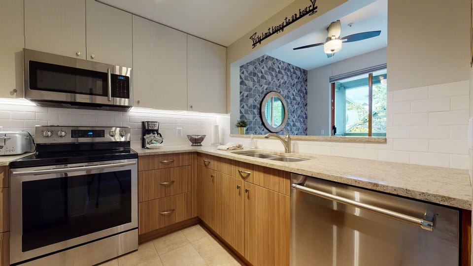 Clean, modern, and functional; the kitchen is stocked and ready for your stay.